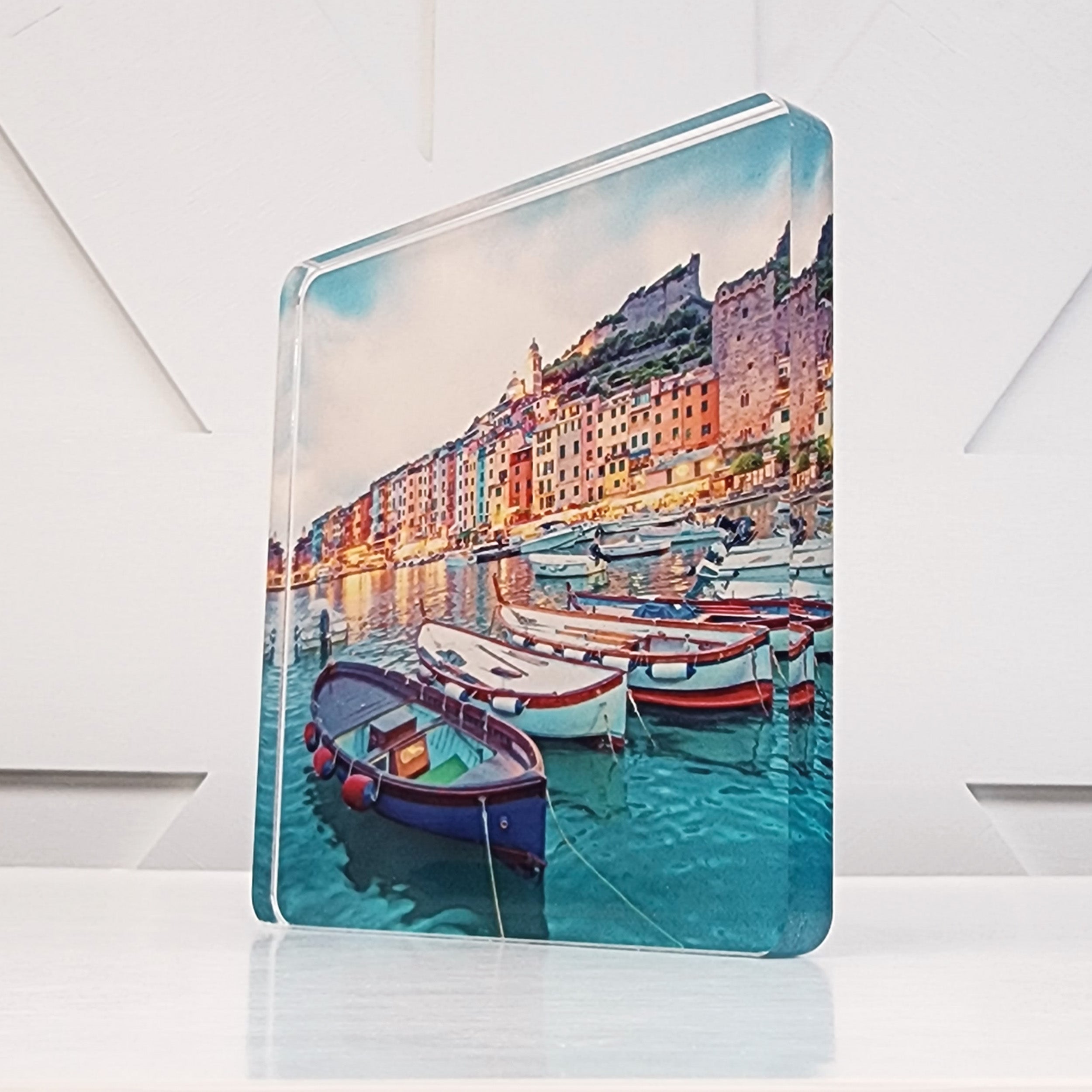 Square acrylic cutout of an image of boats in water.