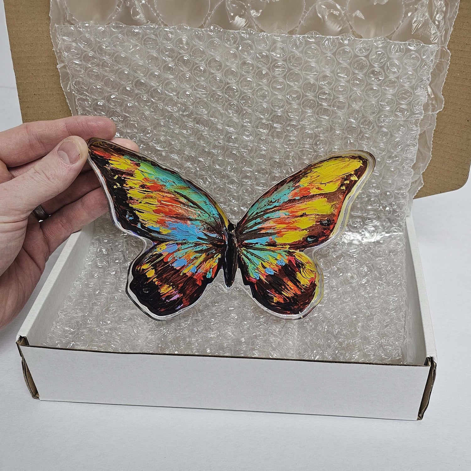 Acrylic cutout art reproduction product inside of a shipping box