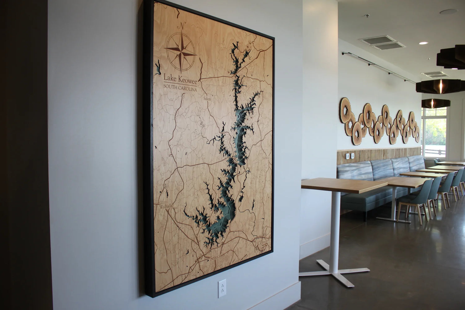 Laser cut and painted Lake Keowee Map hanging a storefront setting.