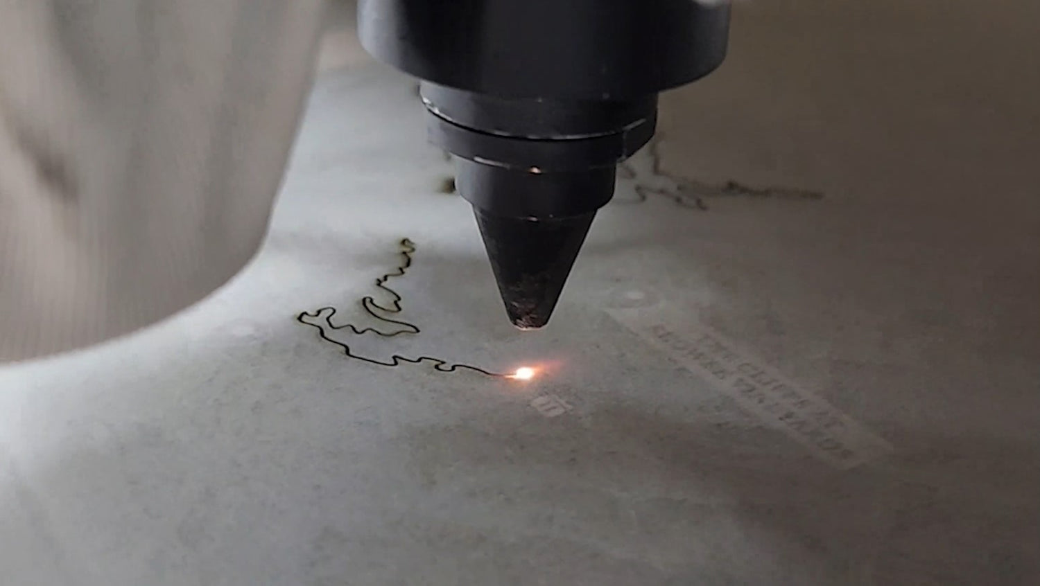 Laser Cut Closeup of machine running, cutting lake image.