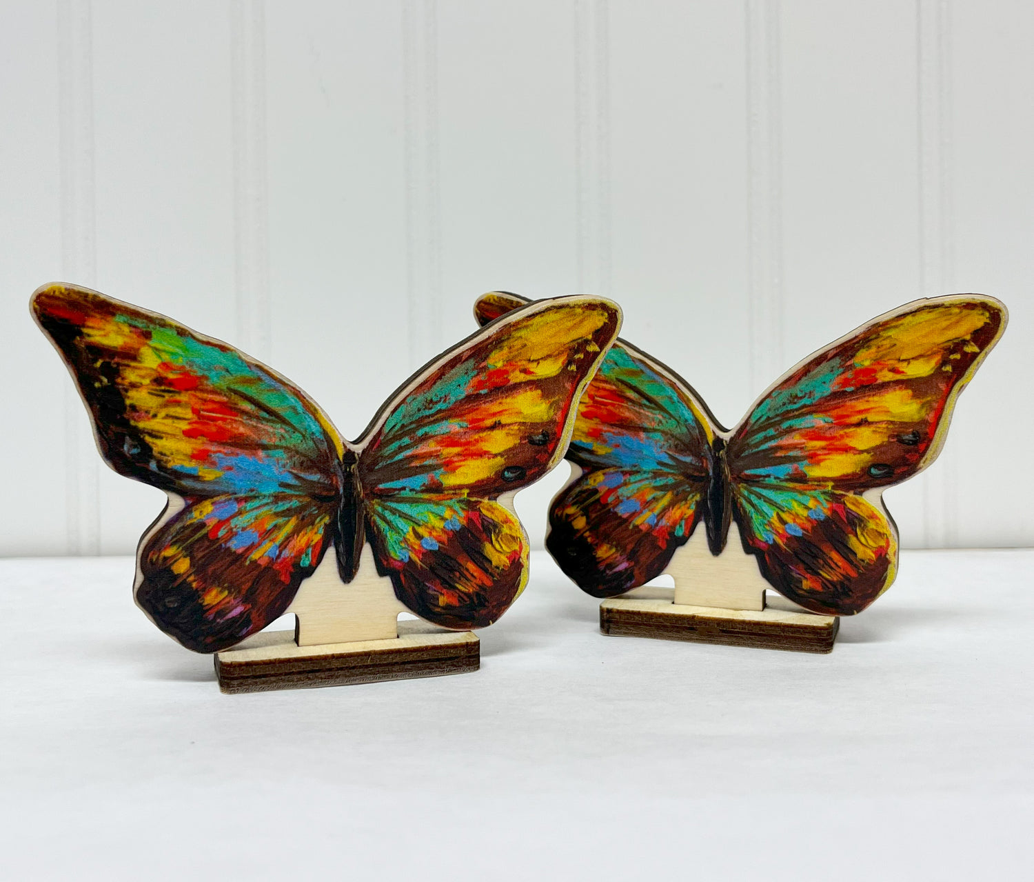 Wood cutouts of butterflies with stands.